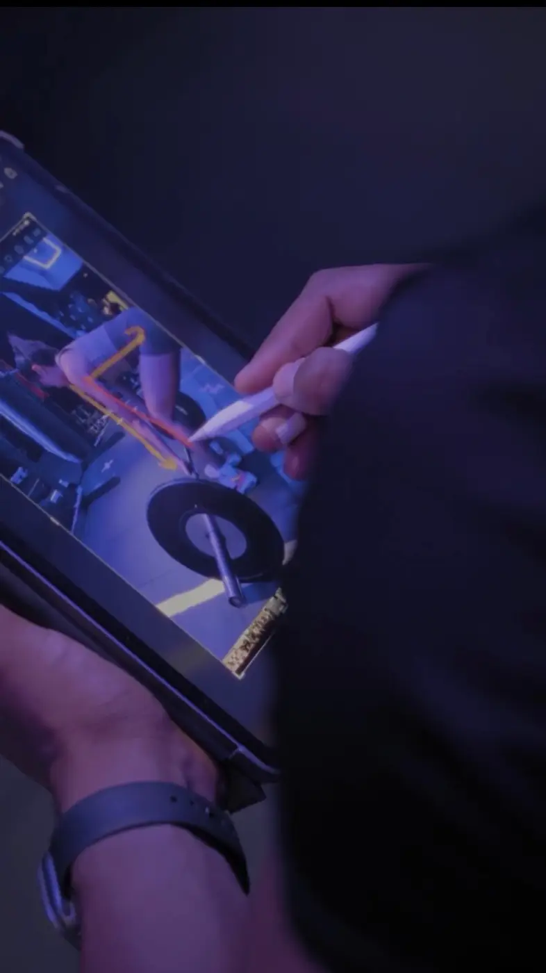 Coach marking up a client's lift on a tablet